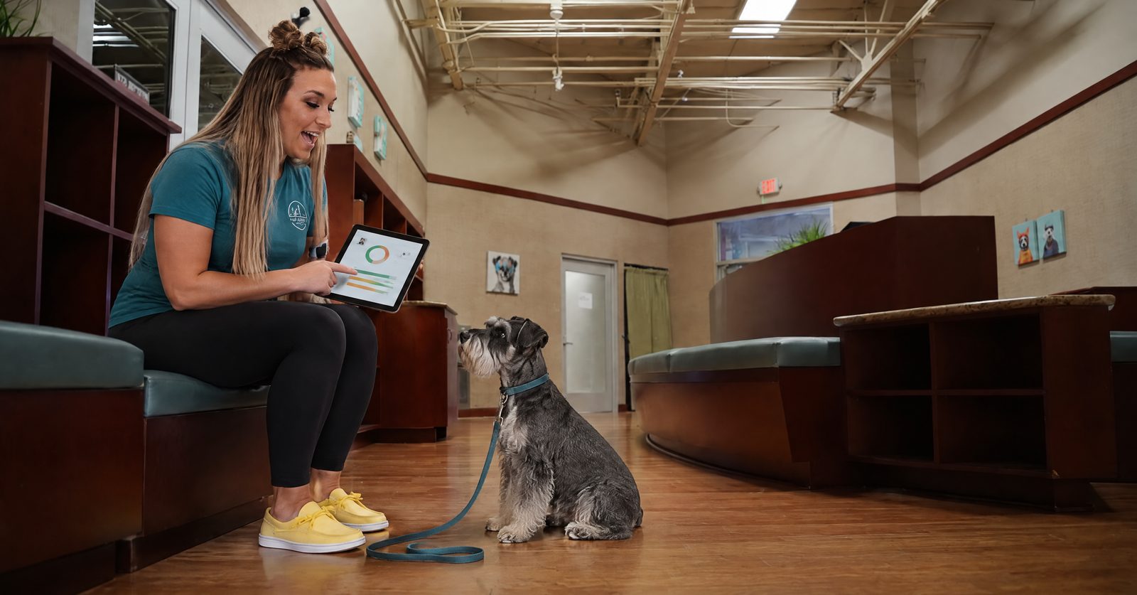 Trainer reviewing a PD360 Assessment scorecard on a tablet with a Pet Parent in Cave Creek