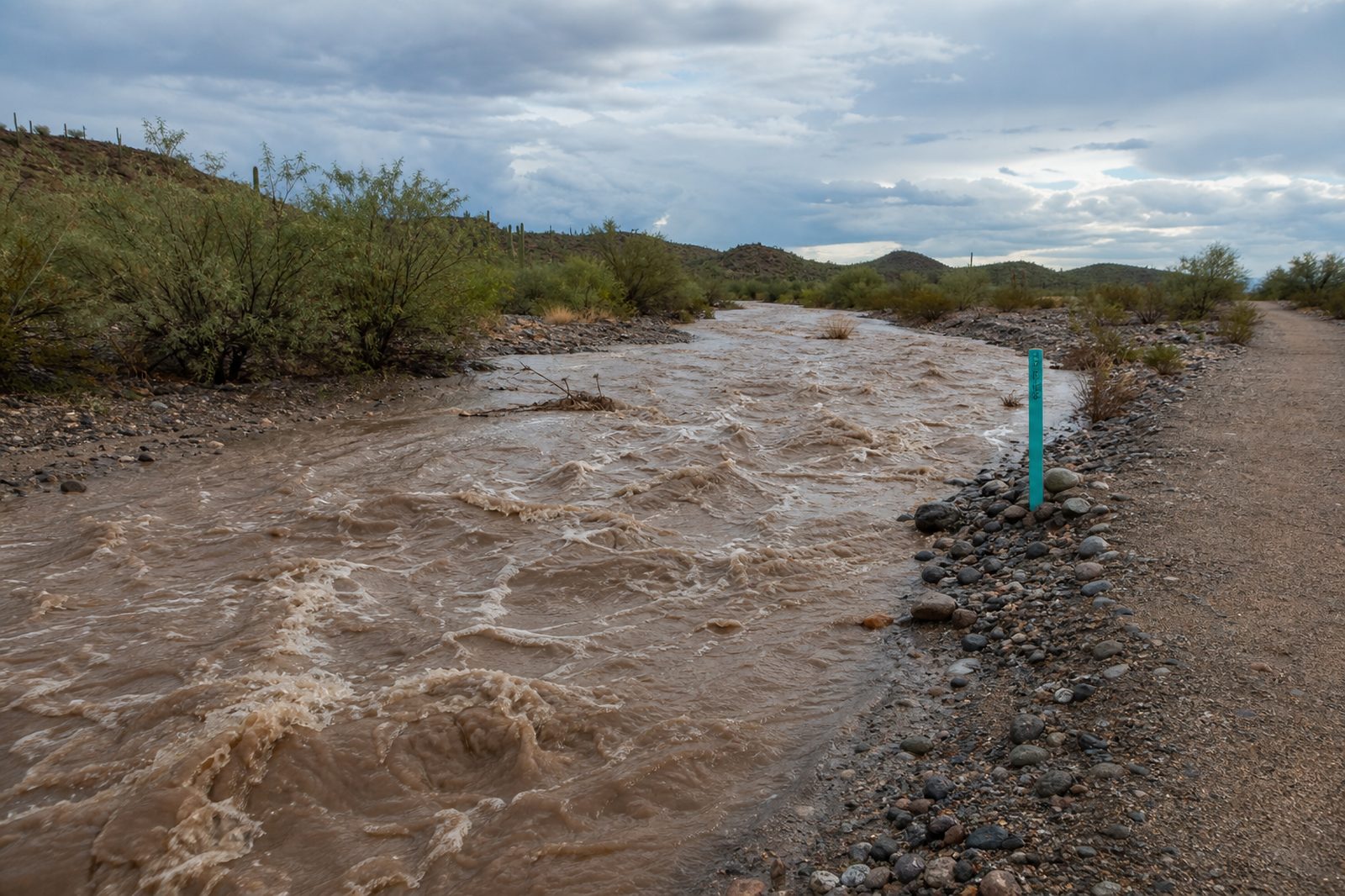 Flooded desert wash crossing a monsoon hiking trail in the McDowell Sonoran Preserve after a storm